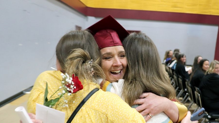 Woman hugging her family during the convocation ceremony