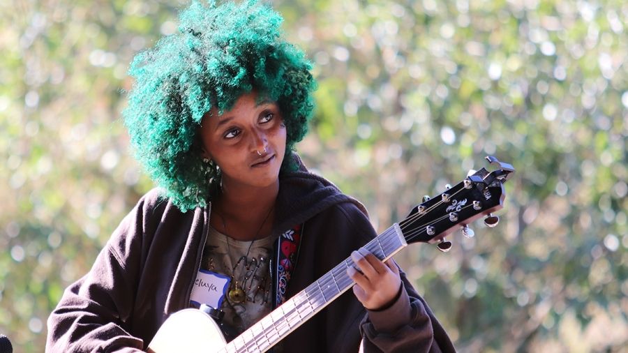 Haleluya Hailu playing guitar