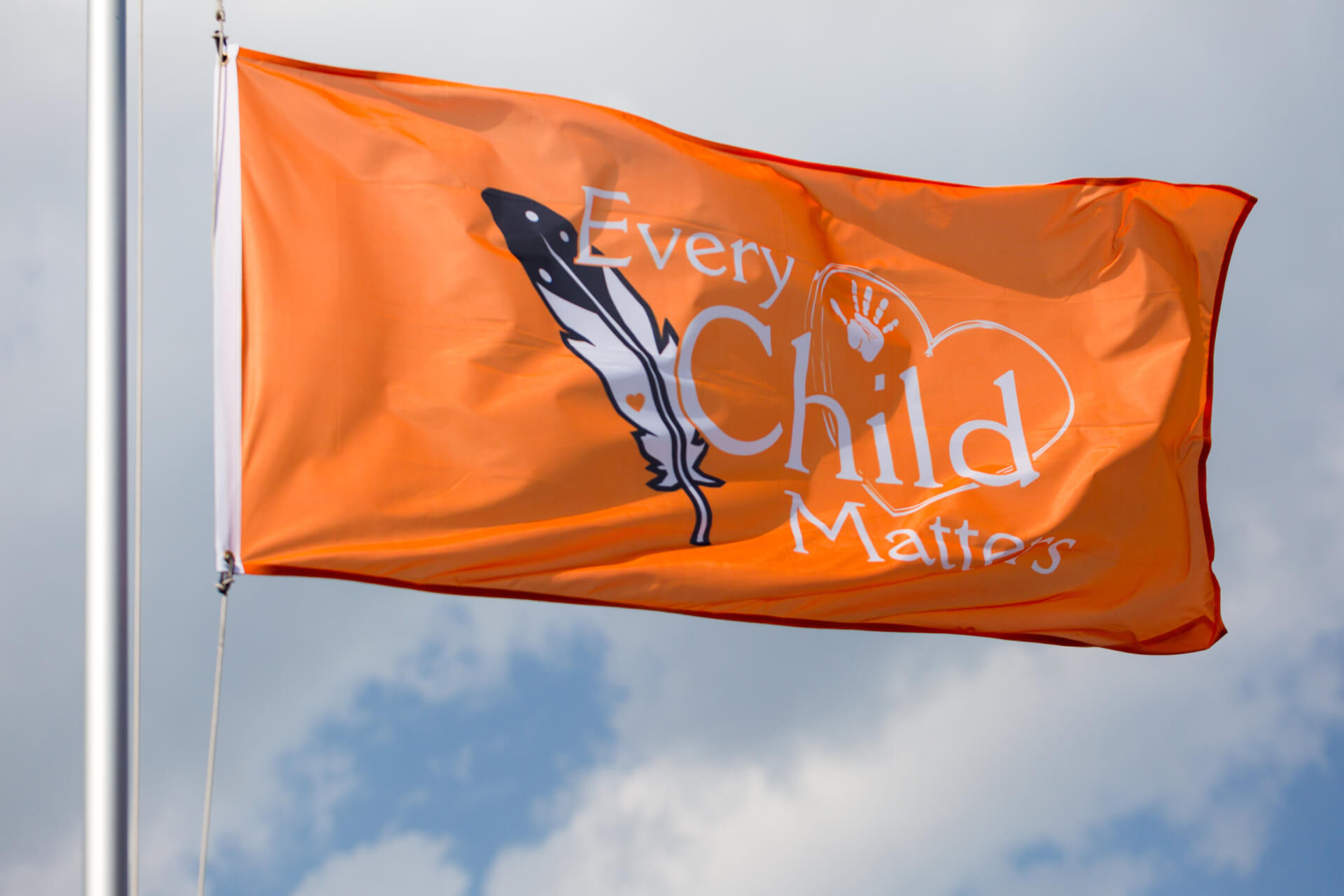 An image of an orange flag that reads Every Child Matters