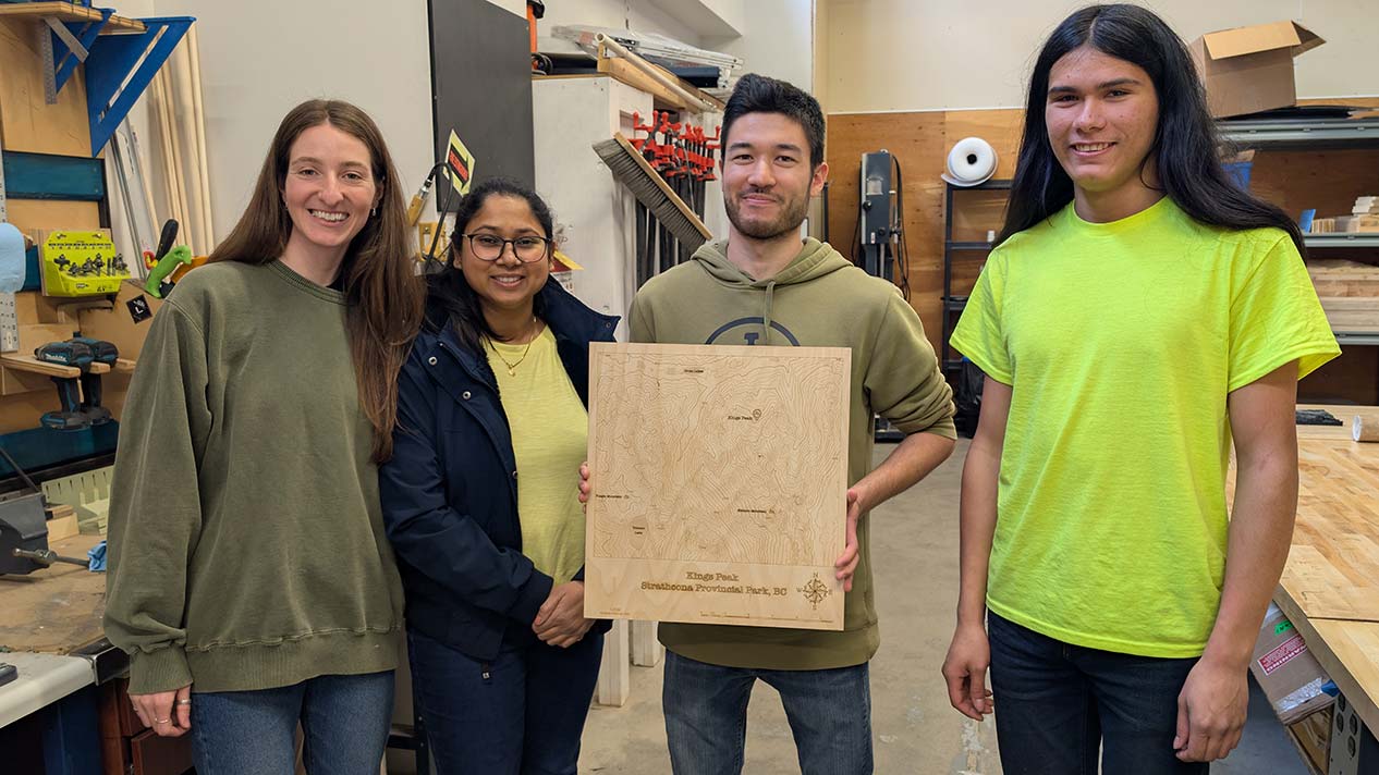 Four students at STAC with their project