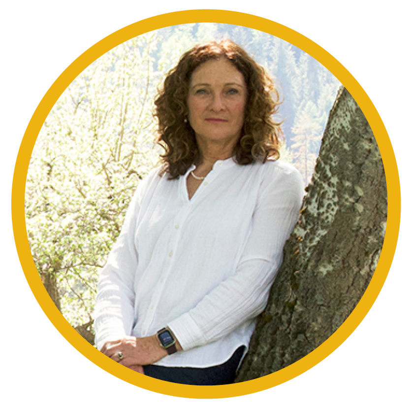 A person leans against a tree