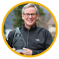 Bob Falle holding an award