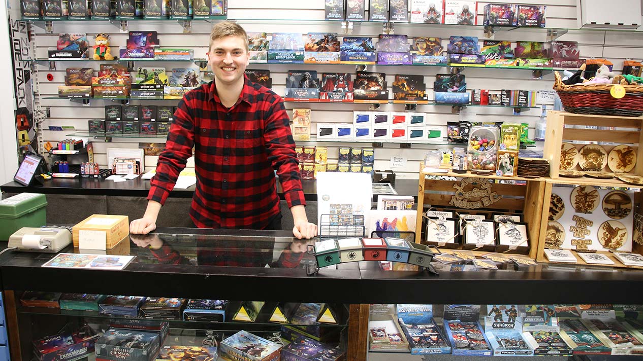 Business Adminstration Program student Brady Stocks in his shop with trading cards