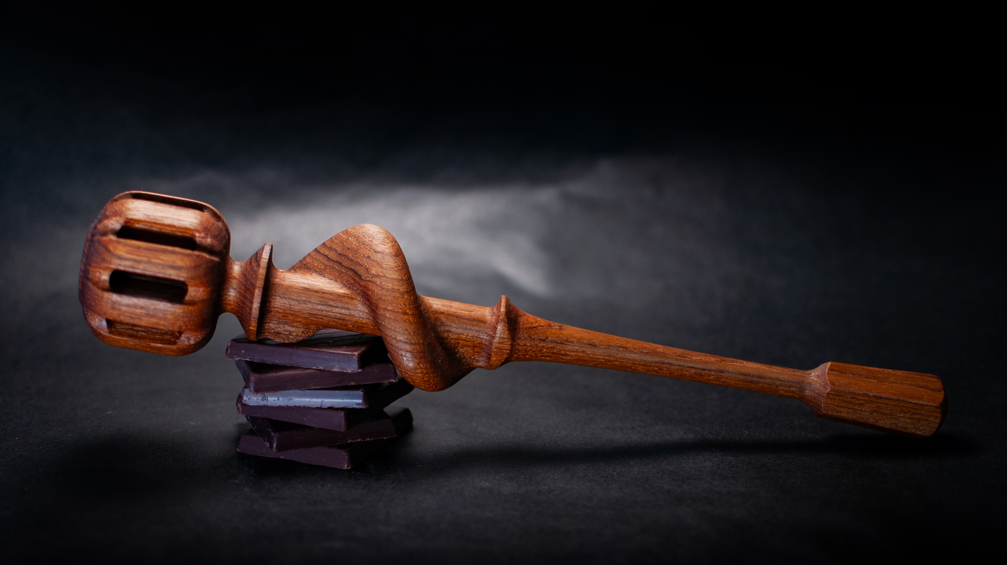 A wooden whisk on a stand