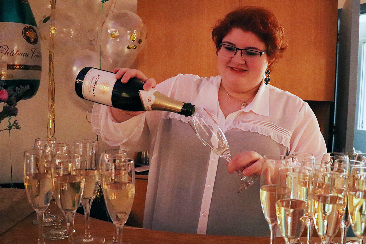 A woman pours champagne