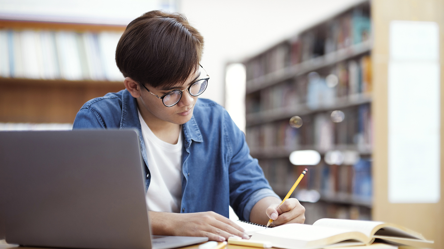 Young man studying in the library