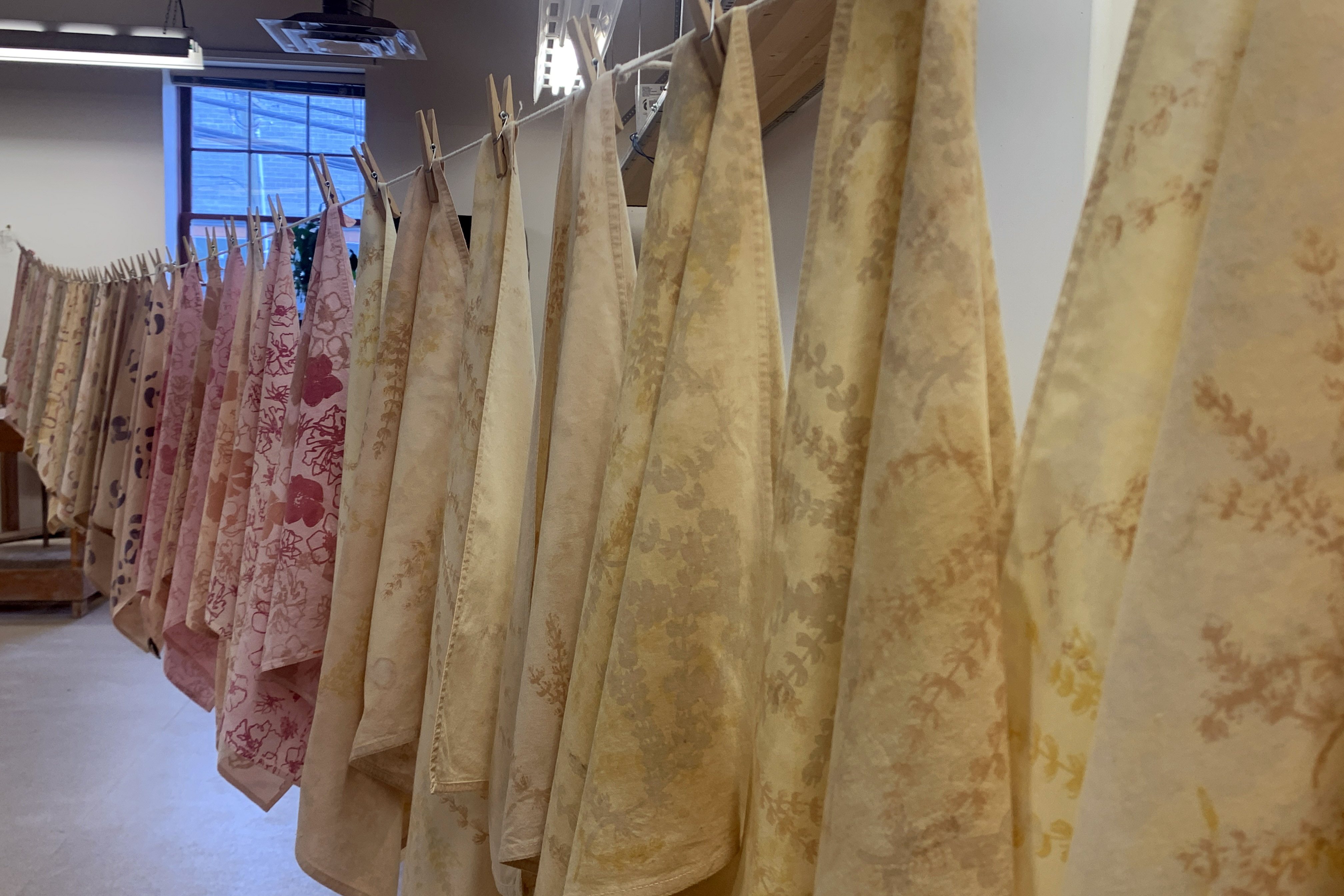 Pink and yellow napkins hanging on washing line