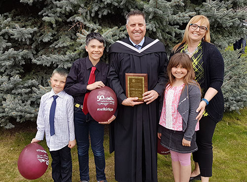 Currently the President and CEO of Panorama Resort in the East Kootenay, Steve Paccagnan's contribution to the industry was recognized in 2017 when he was honoured with the Selkirk College Distinguished Alumni Award at the annual Convocation at the Castlegar Campus. Steve posed for a photo with his family after the cermony.