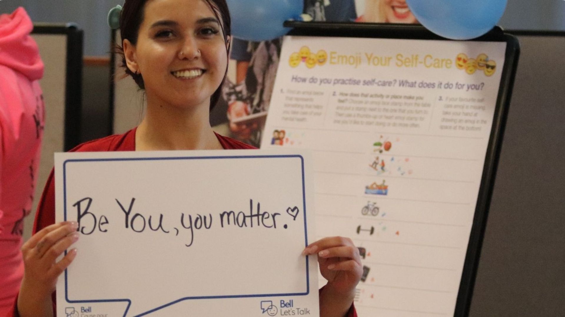 Student holding sign saying "Be You, You Matter"