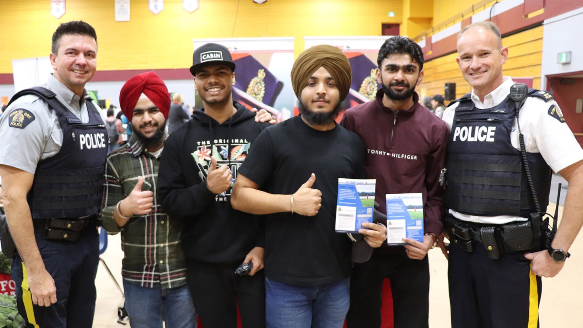 A group of students stand with police officers