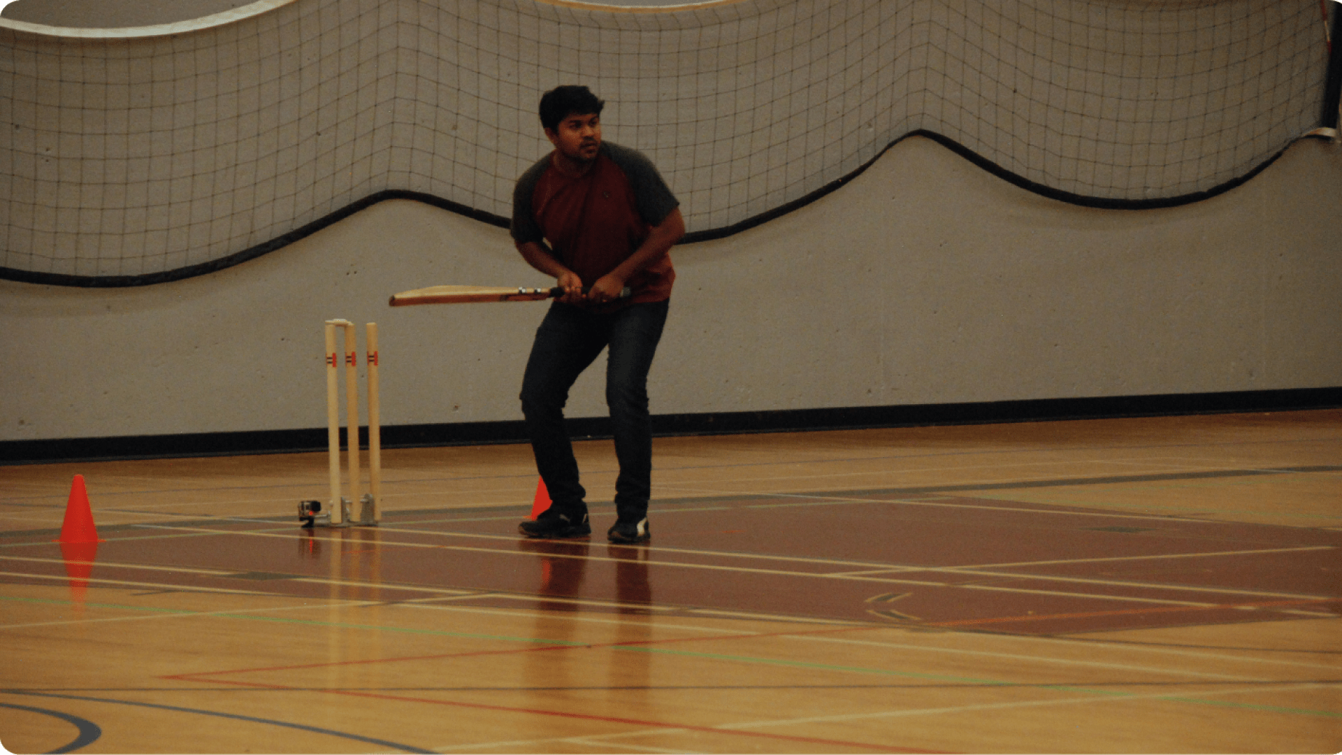 student playing cricket