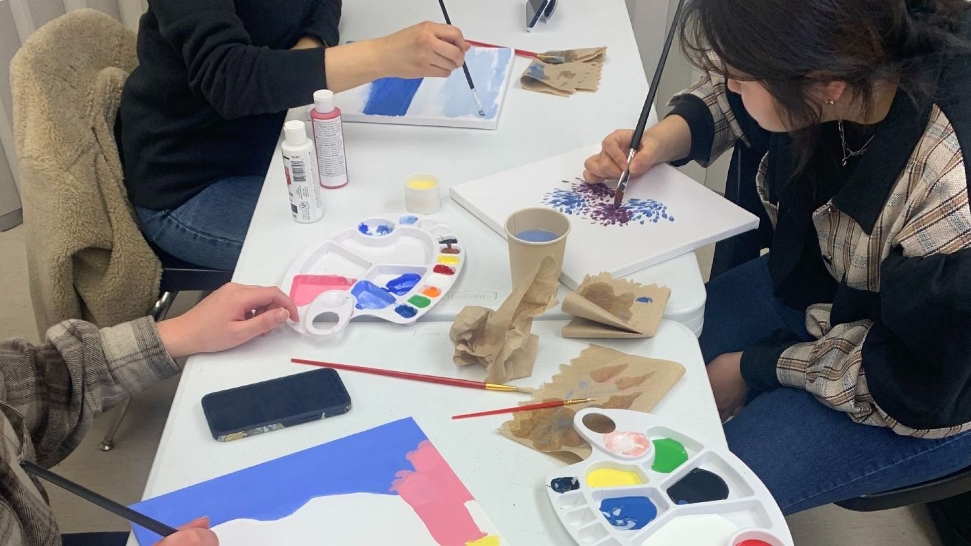 Students Painting on Canvases