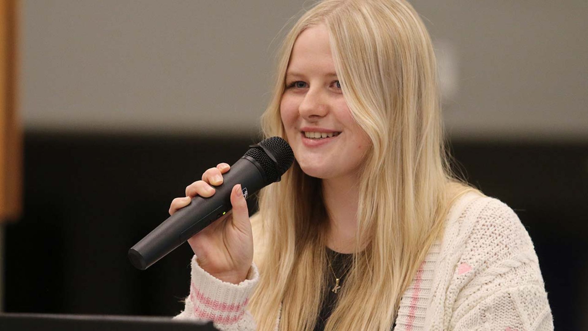 Bursary recipient Maddy Bradford speaking at podium