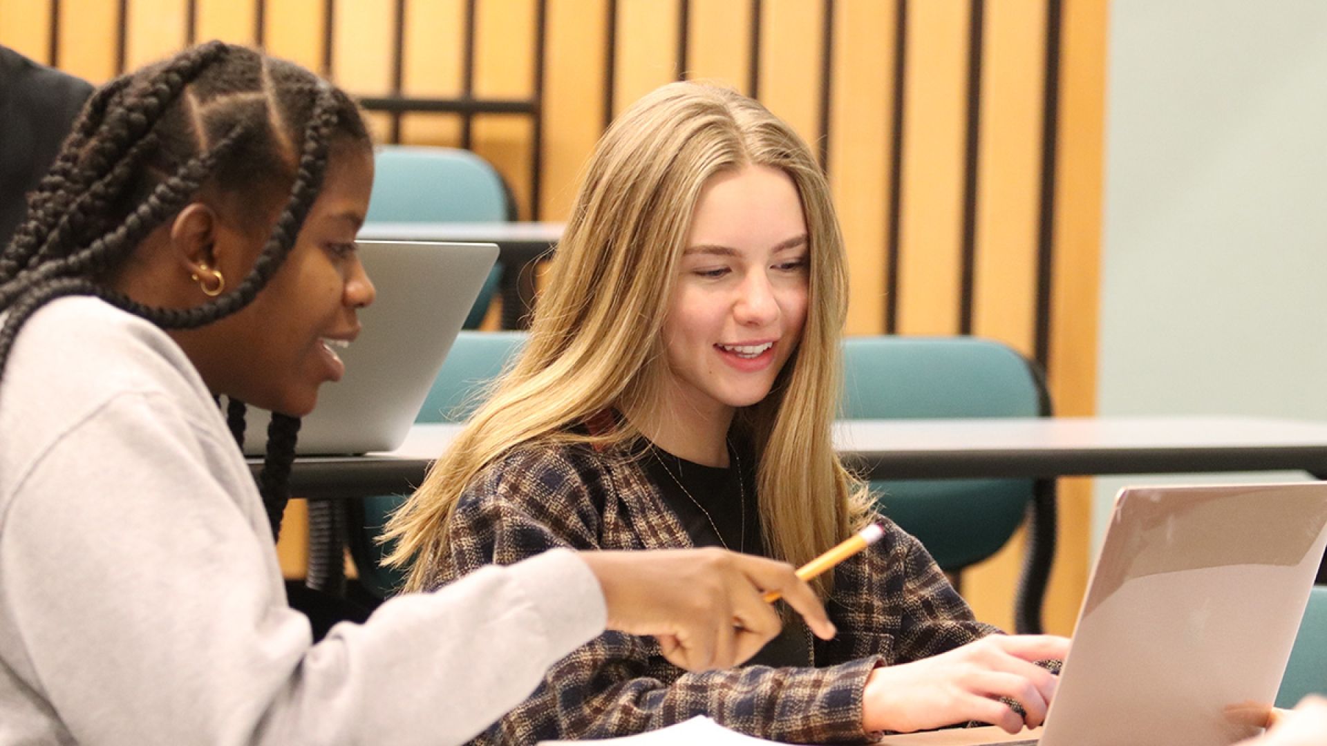 Business students looking at a laptop screen