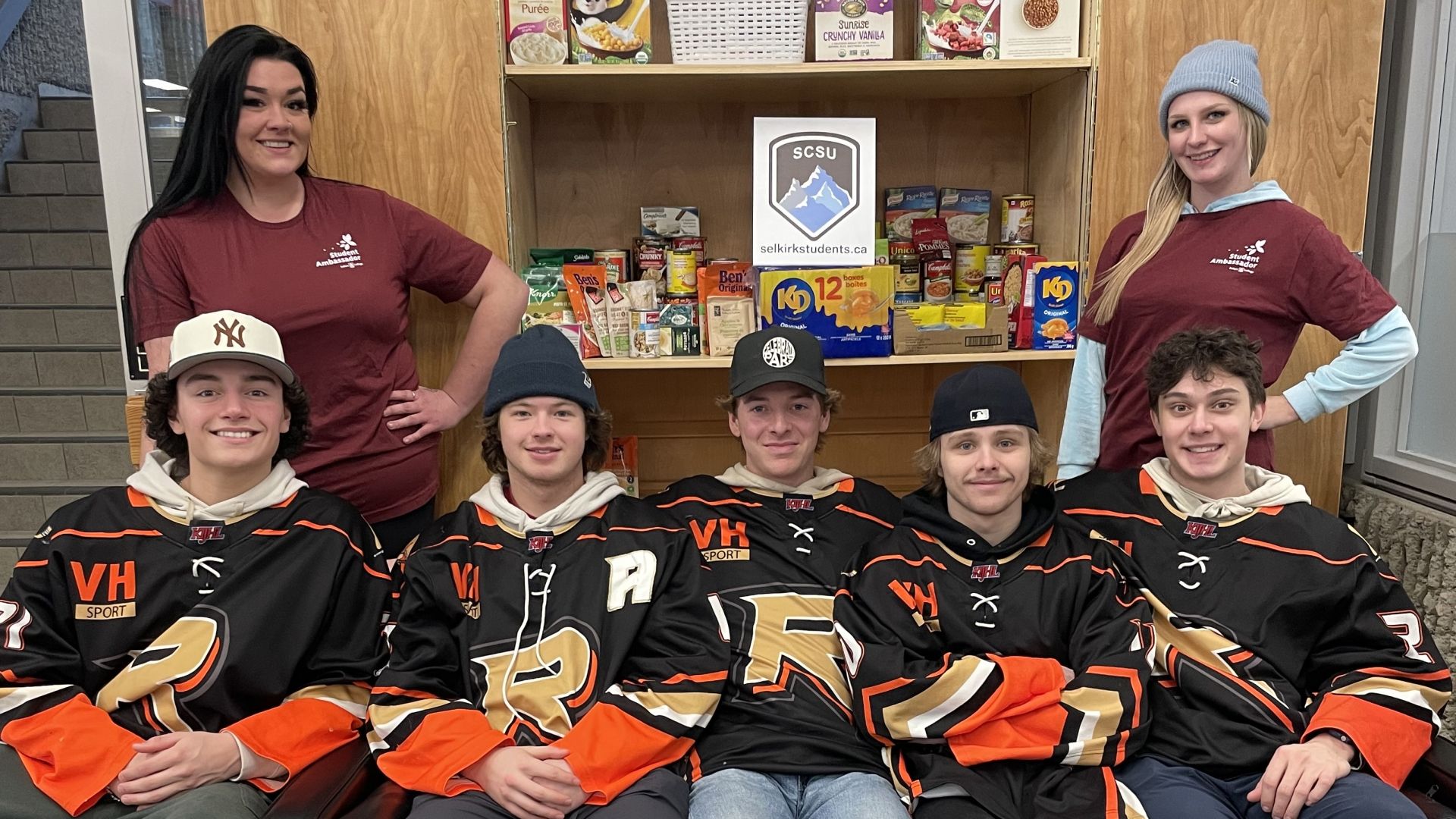 Castlegar Rebels sit wearing their uniforms