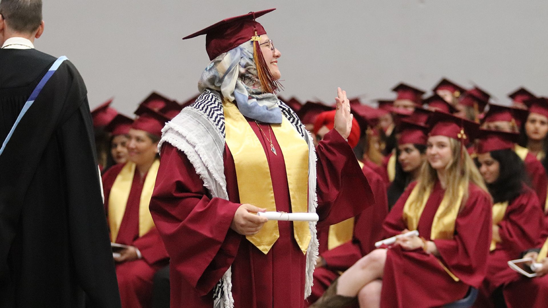 Selkirk College graduate waves to crowd