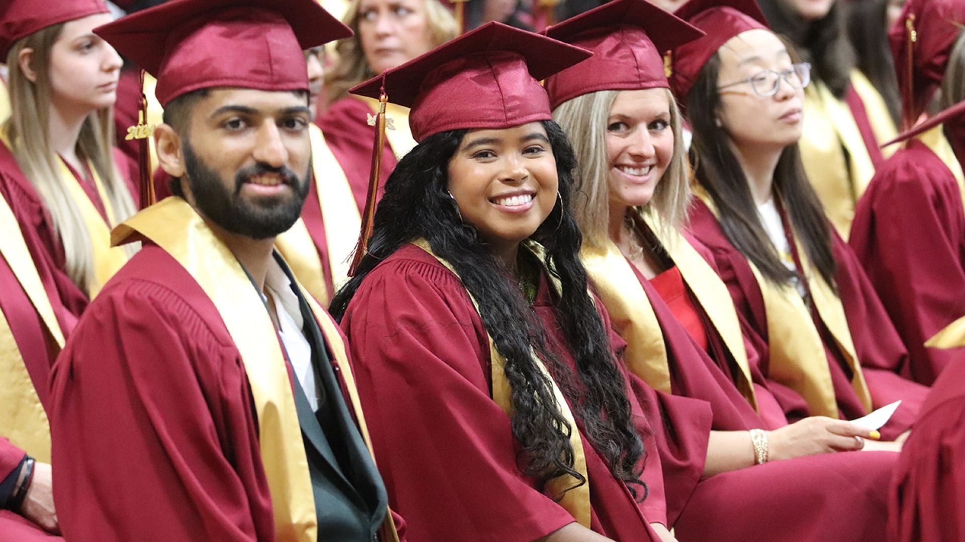 Selkirk College female graduate with big smiles
