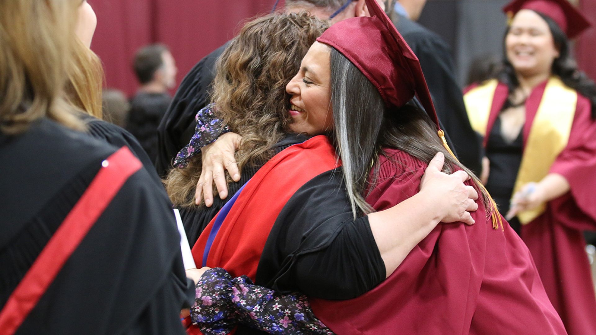 Selkirk College graduate hugging instructor