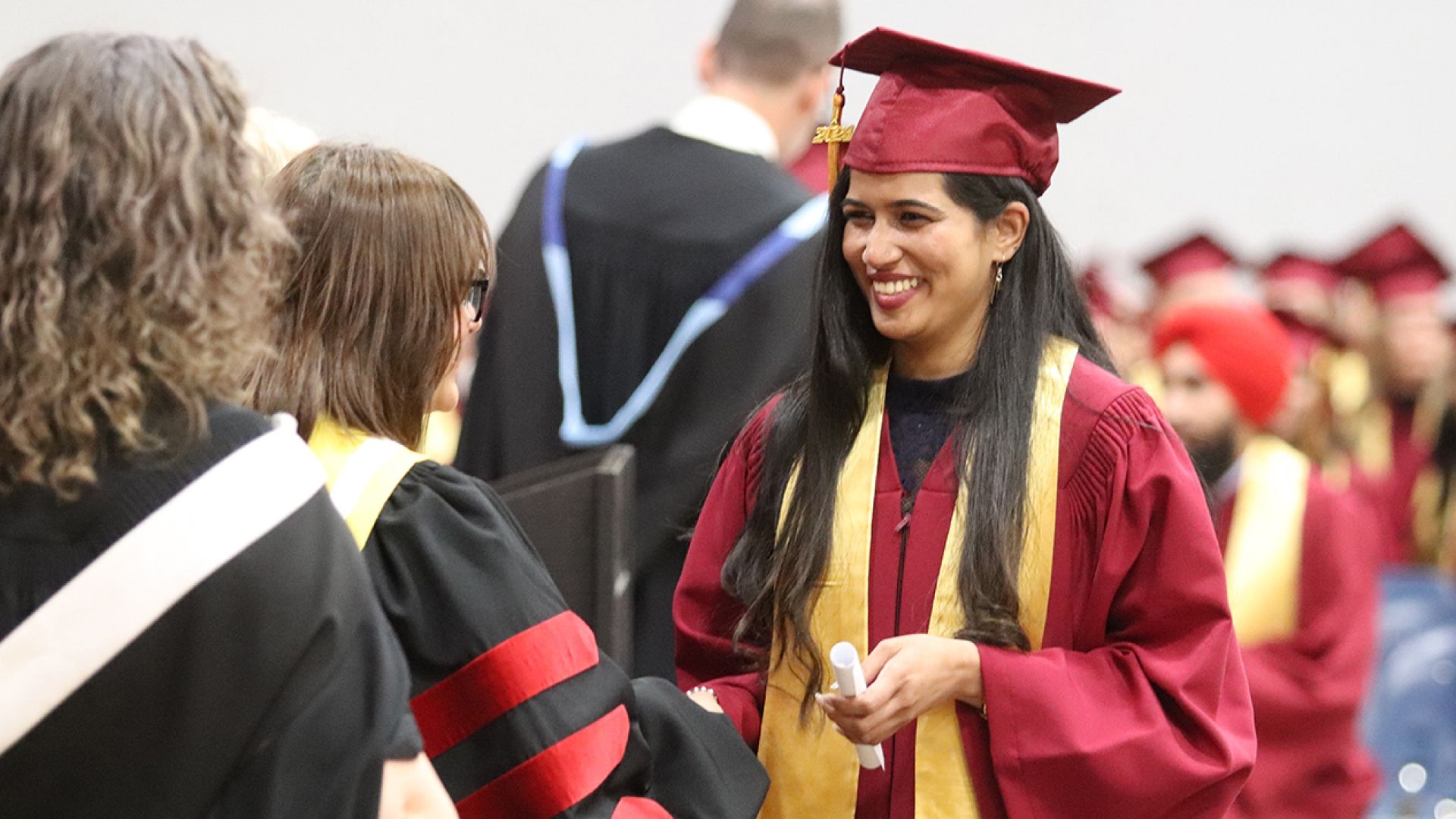 Selkirk College graduate shakes hands with president