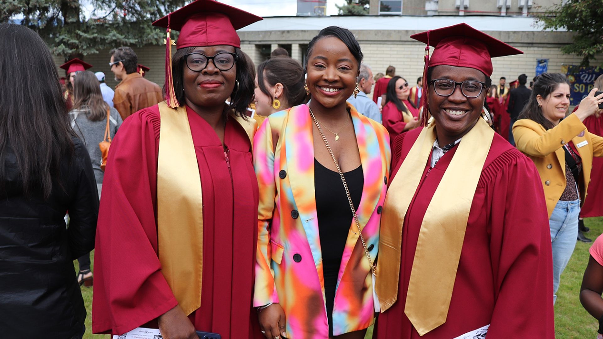 Grads gather with friends on lawn for photo