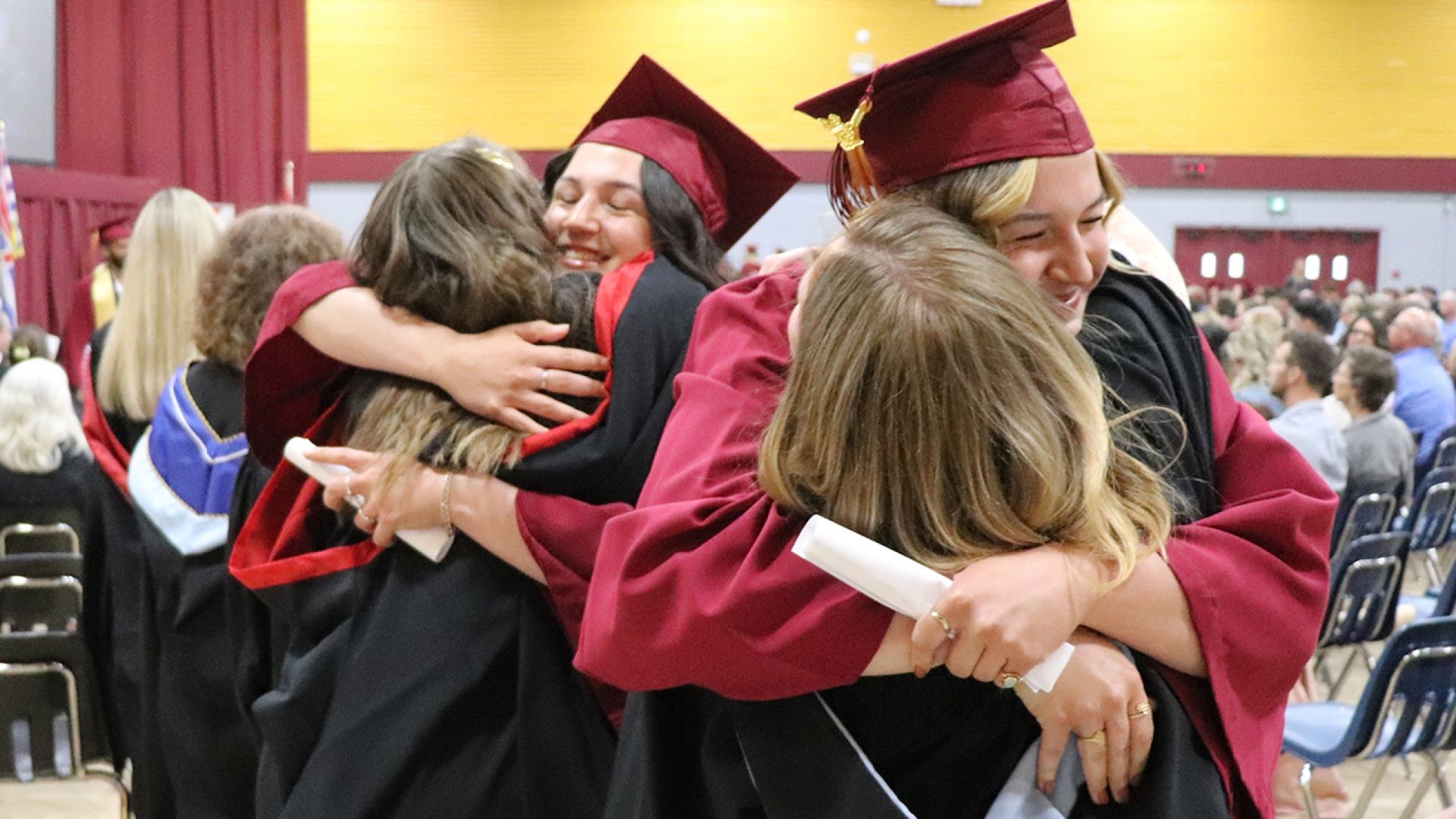 Double hug from graduates