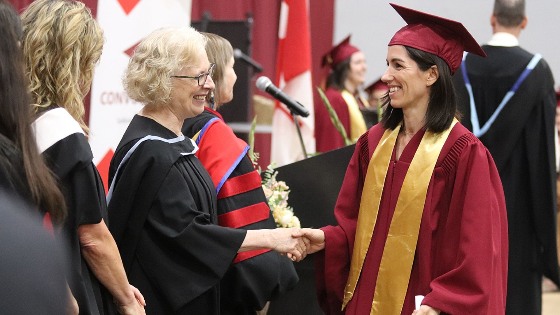 Nursing Program student shakes hand of board of governors chair