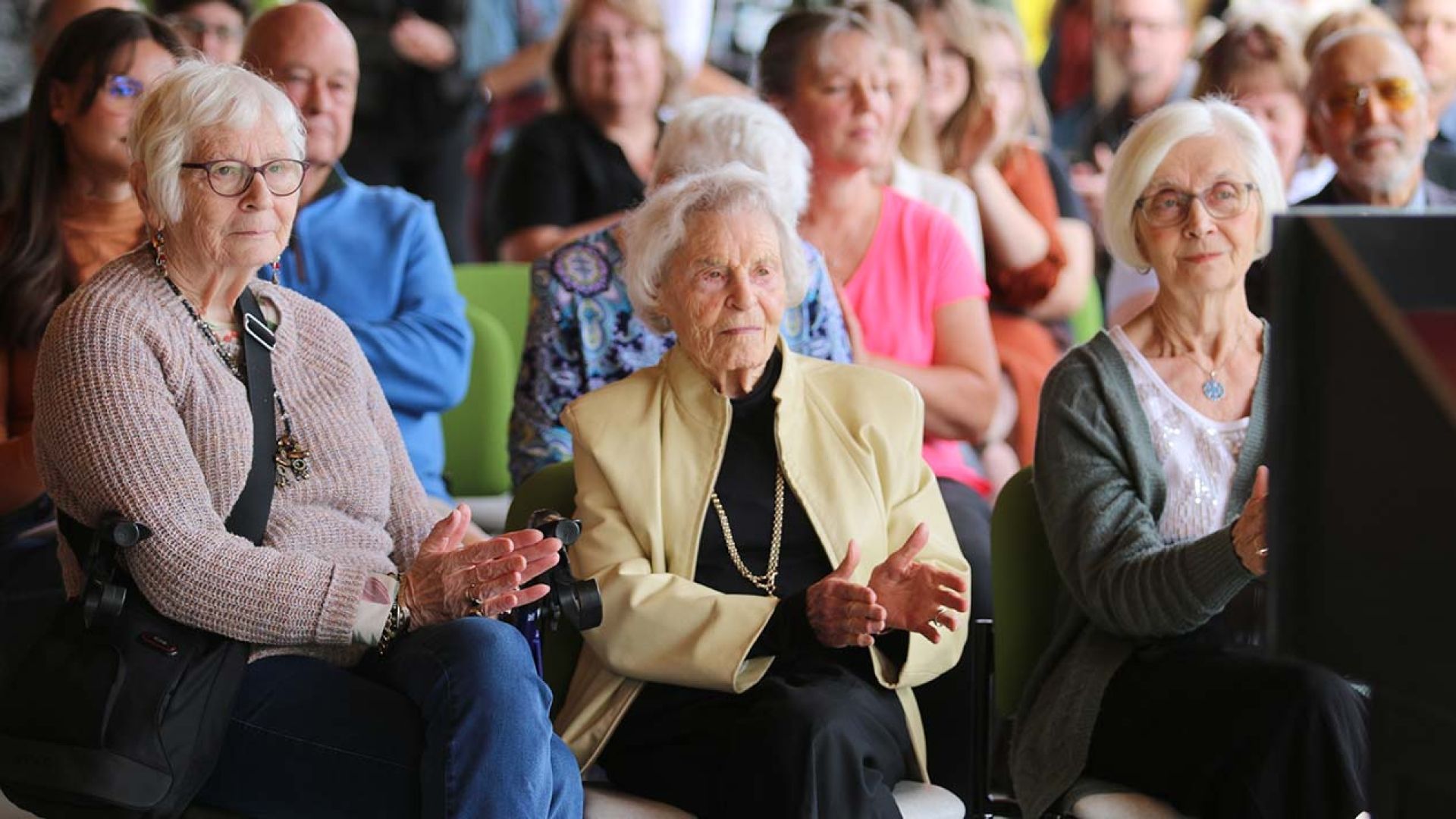 Lifetime Board Member Audrey Moore gathers with others at the student housing opening