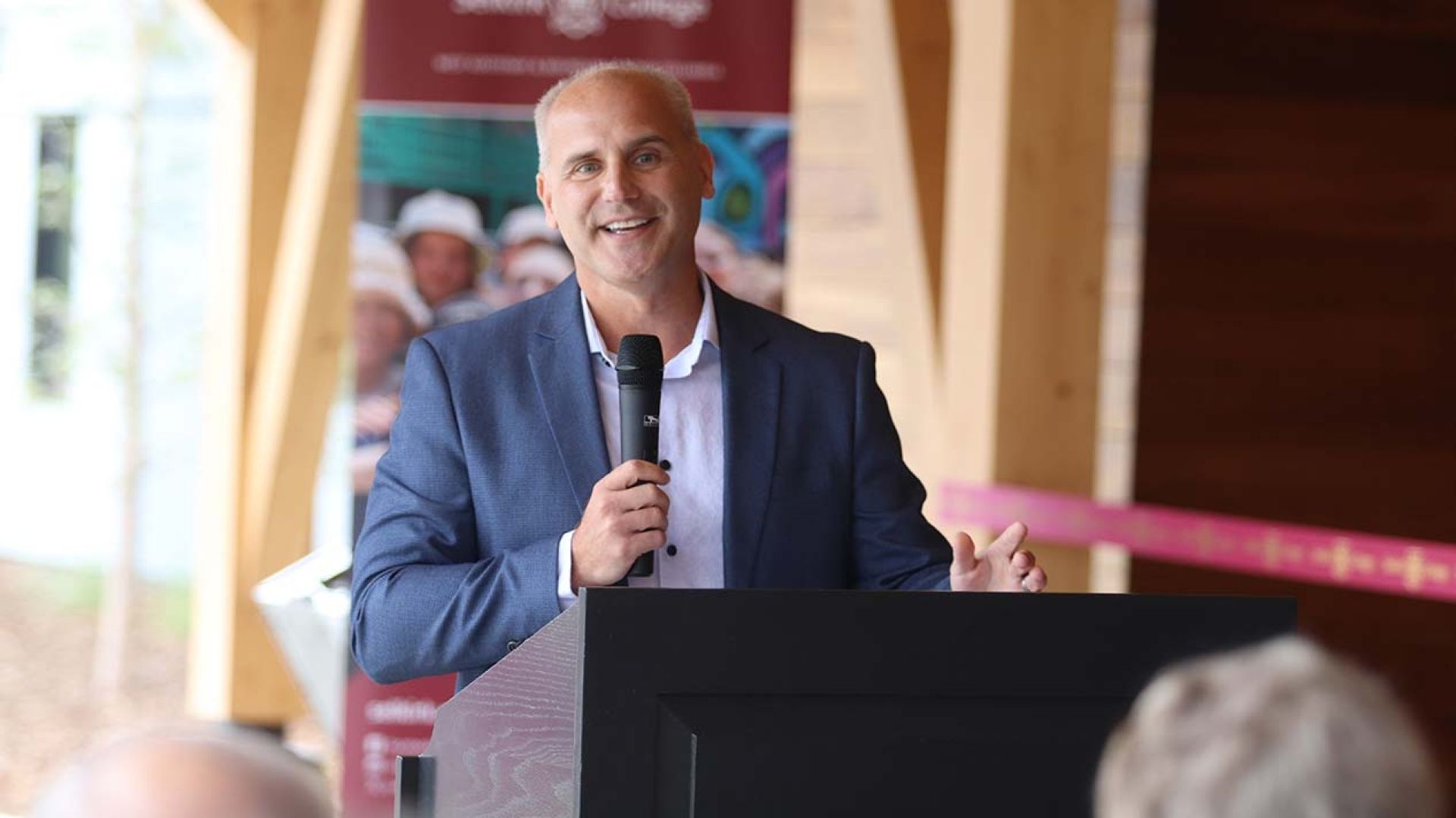 Columbia Basin Trust CEO Johnny Strilaeff at the podium during the housing opening event