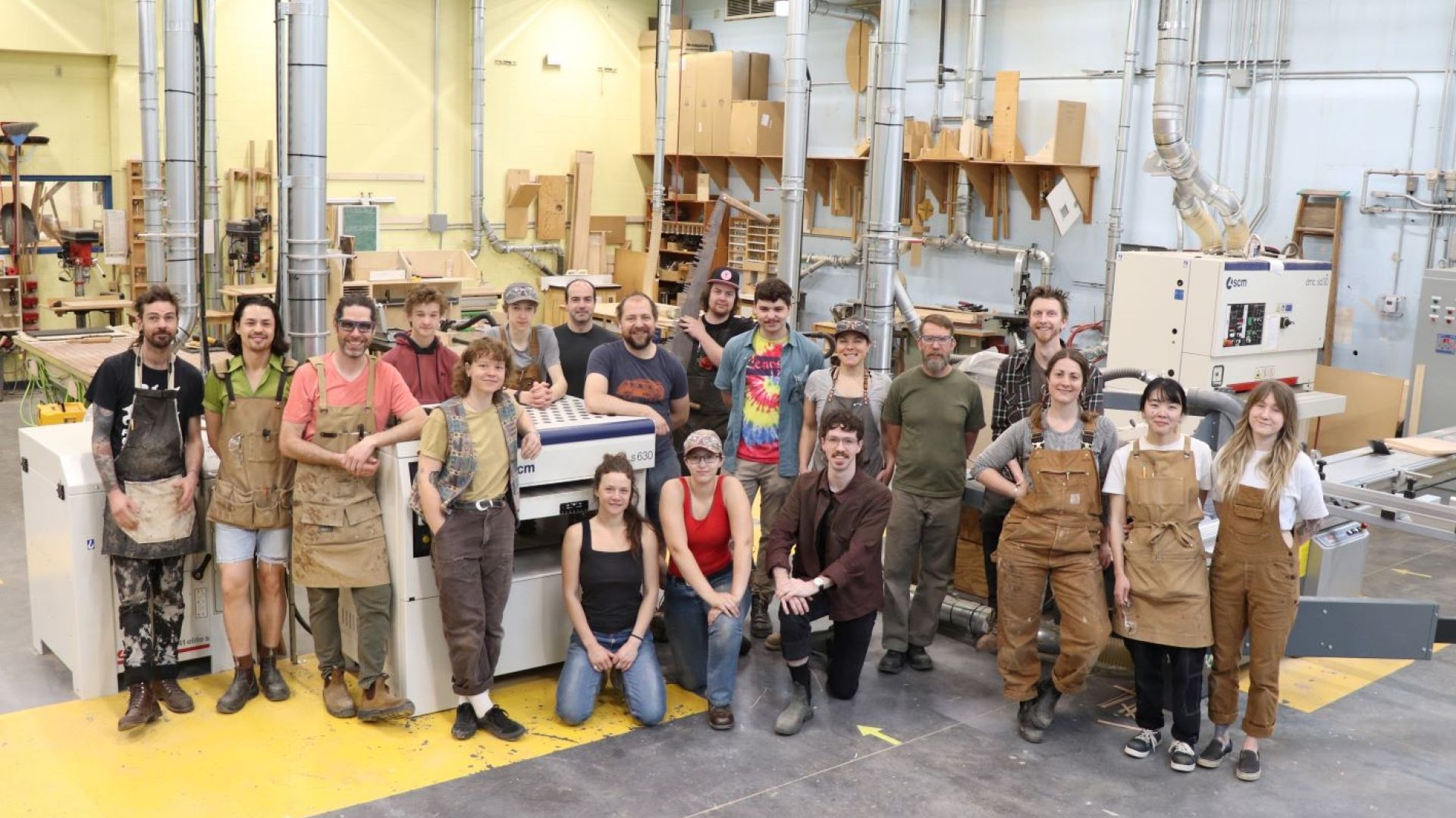 The students of the Fine Woodworking class of 2023 standing in the shop