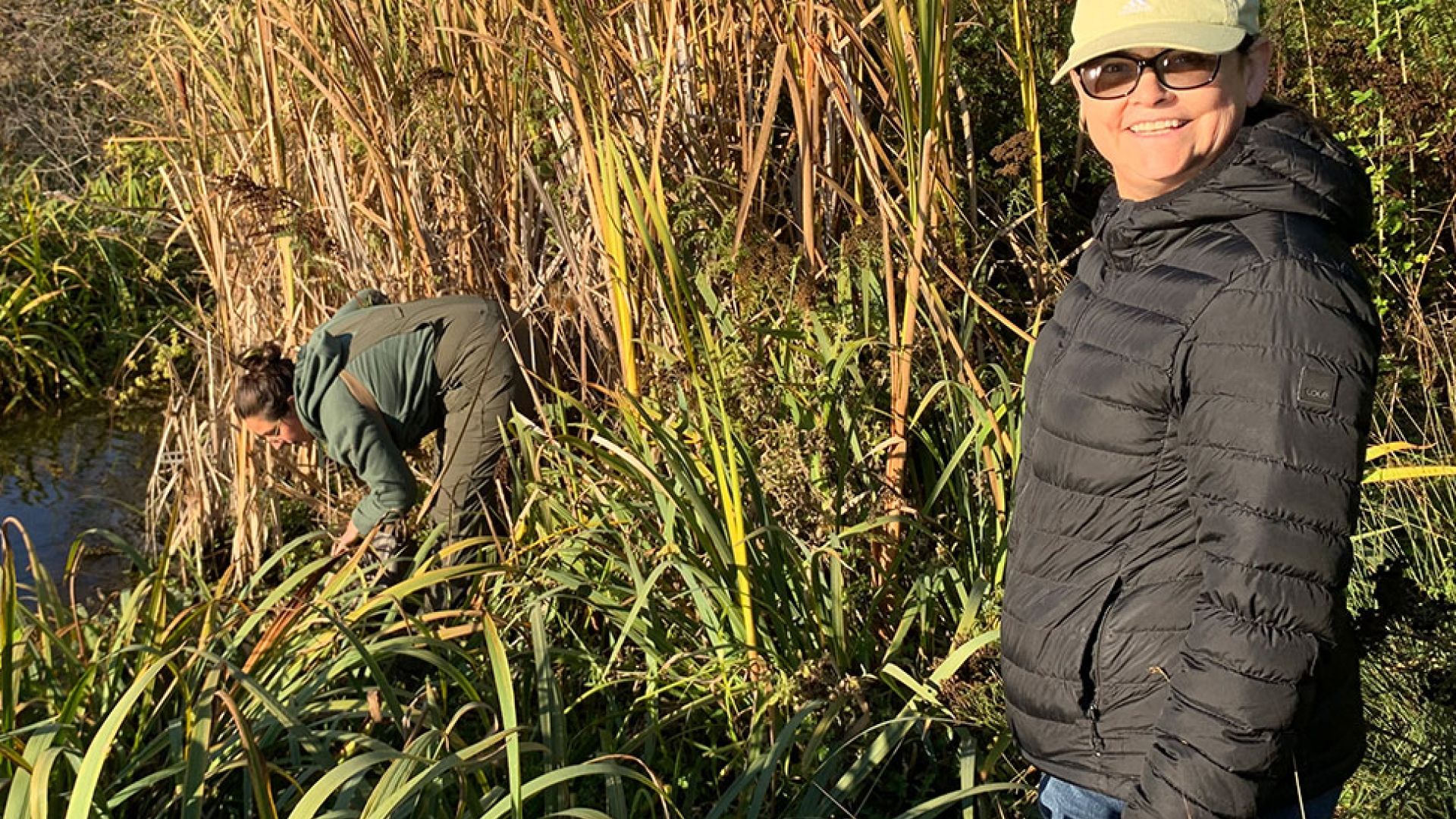 An image of  n̓syilxčn̓ 1 language instructor LaRae Wiley standing among some plants