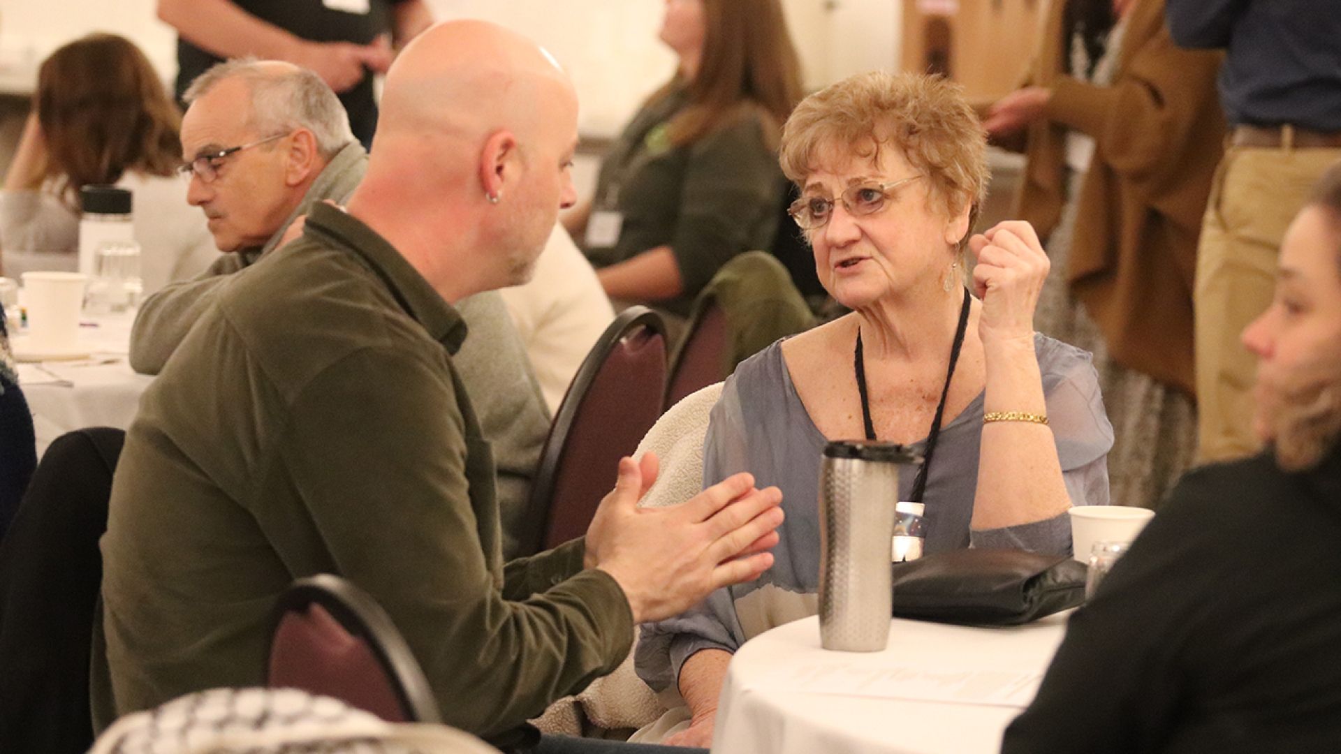 Jesse Woodword, City of Nelson Councilor, engaging with Jan Morton of the Lower Columbia Affordable Housing Society