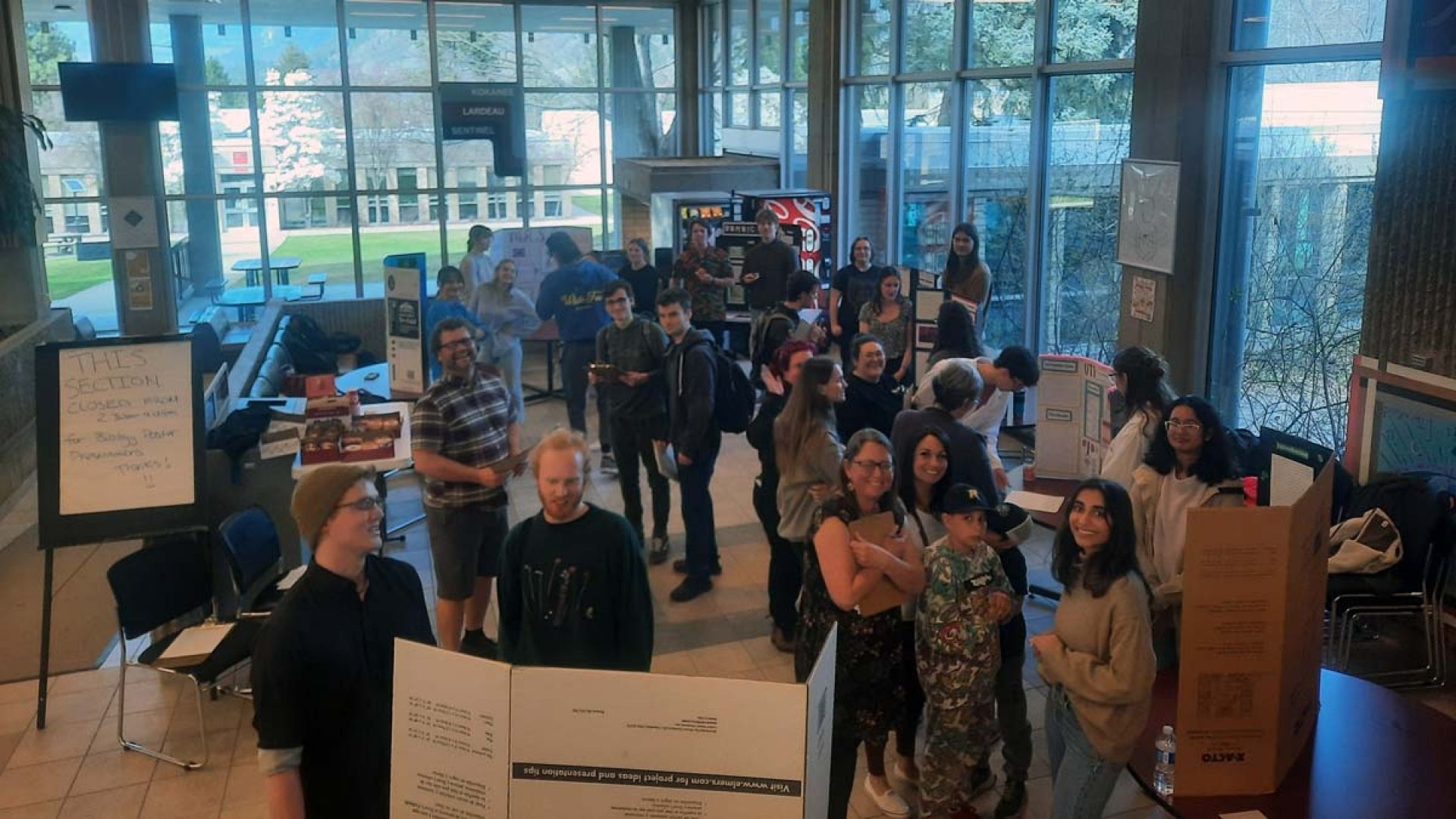 Students gather in The Pit and browse microbiology posters