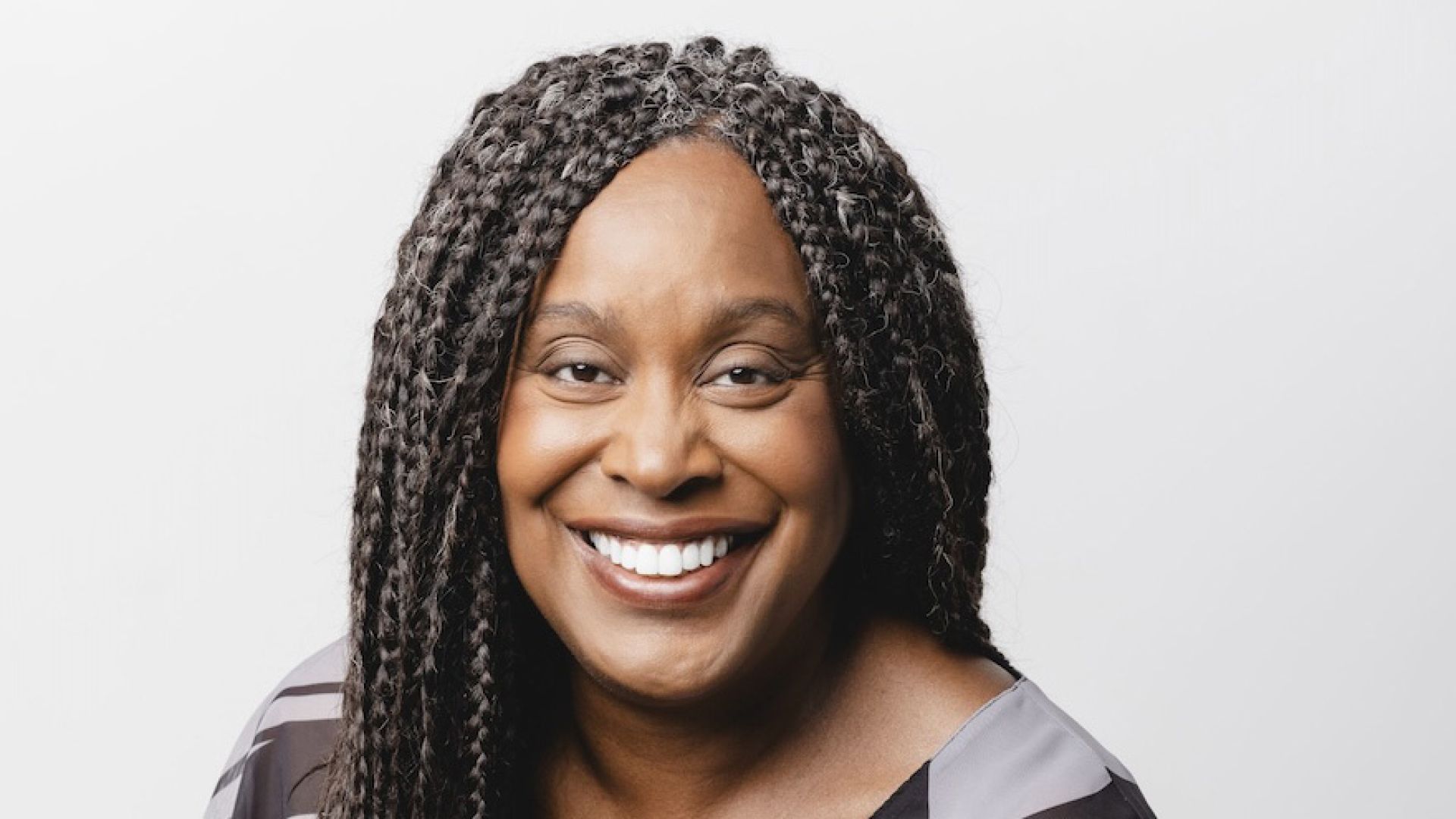 A black woman poses for a headshot