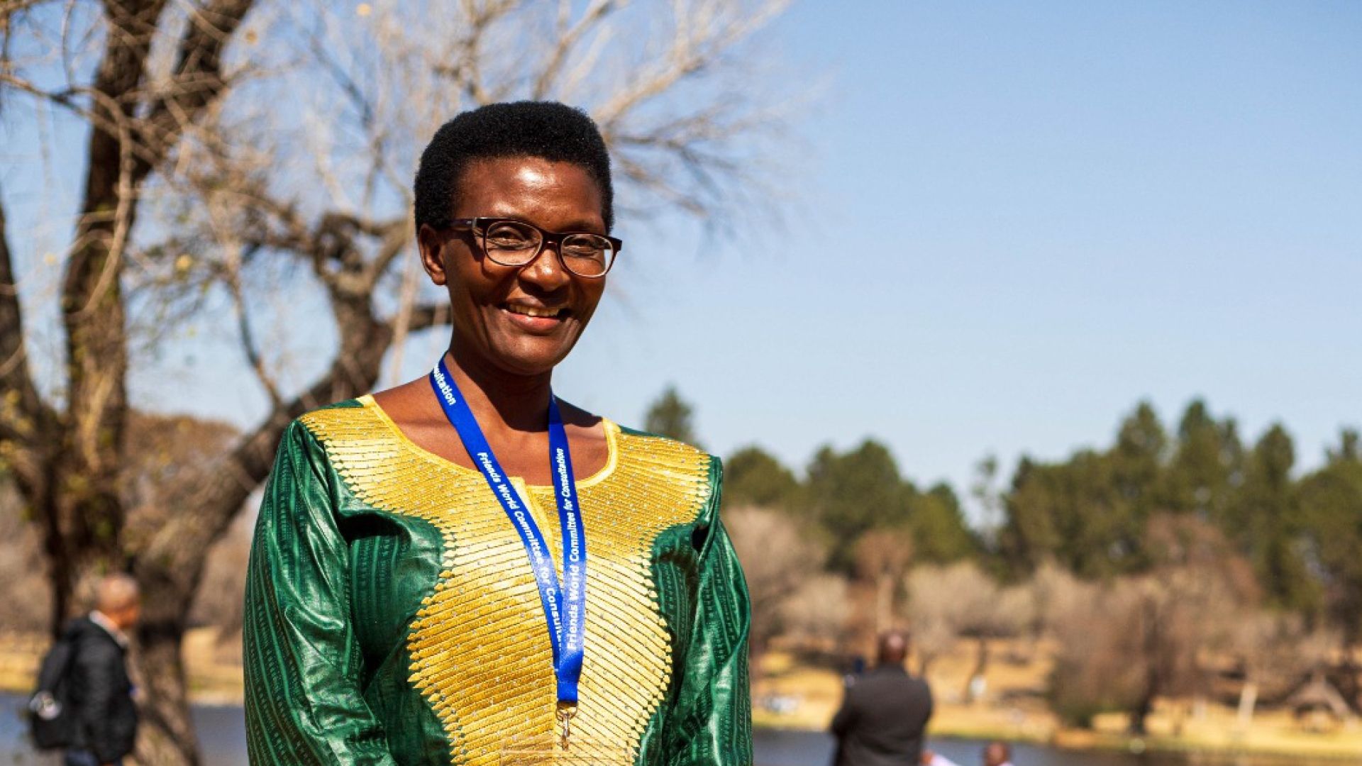 A woman poses for a portrait on a sunny day.
