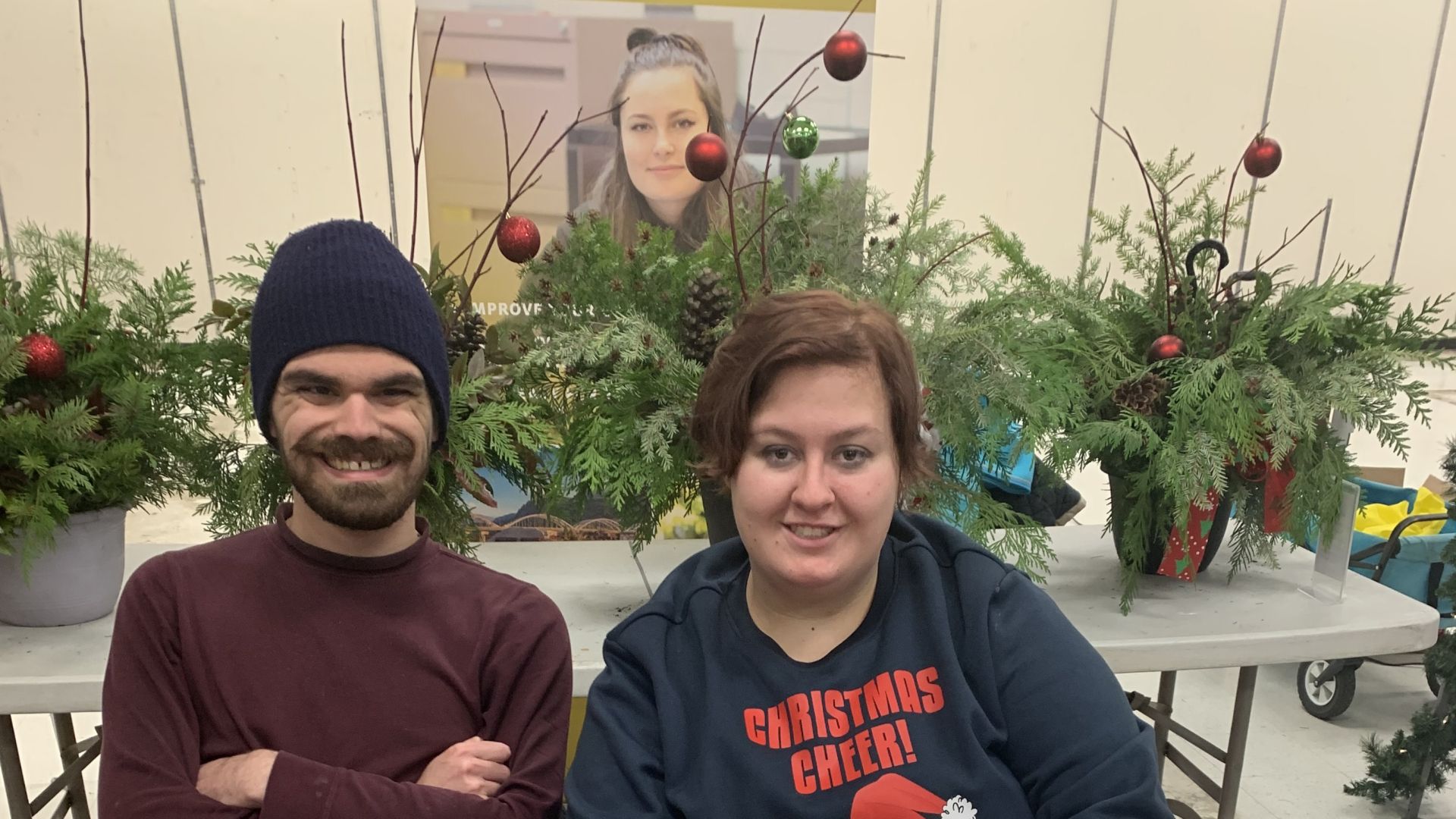 Two students sit at a table at a Christmas market