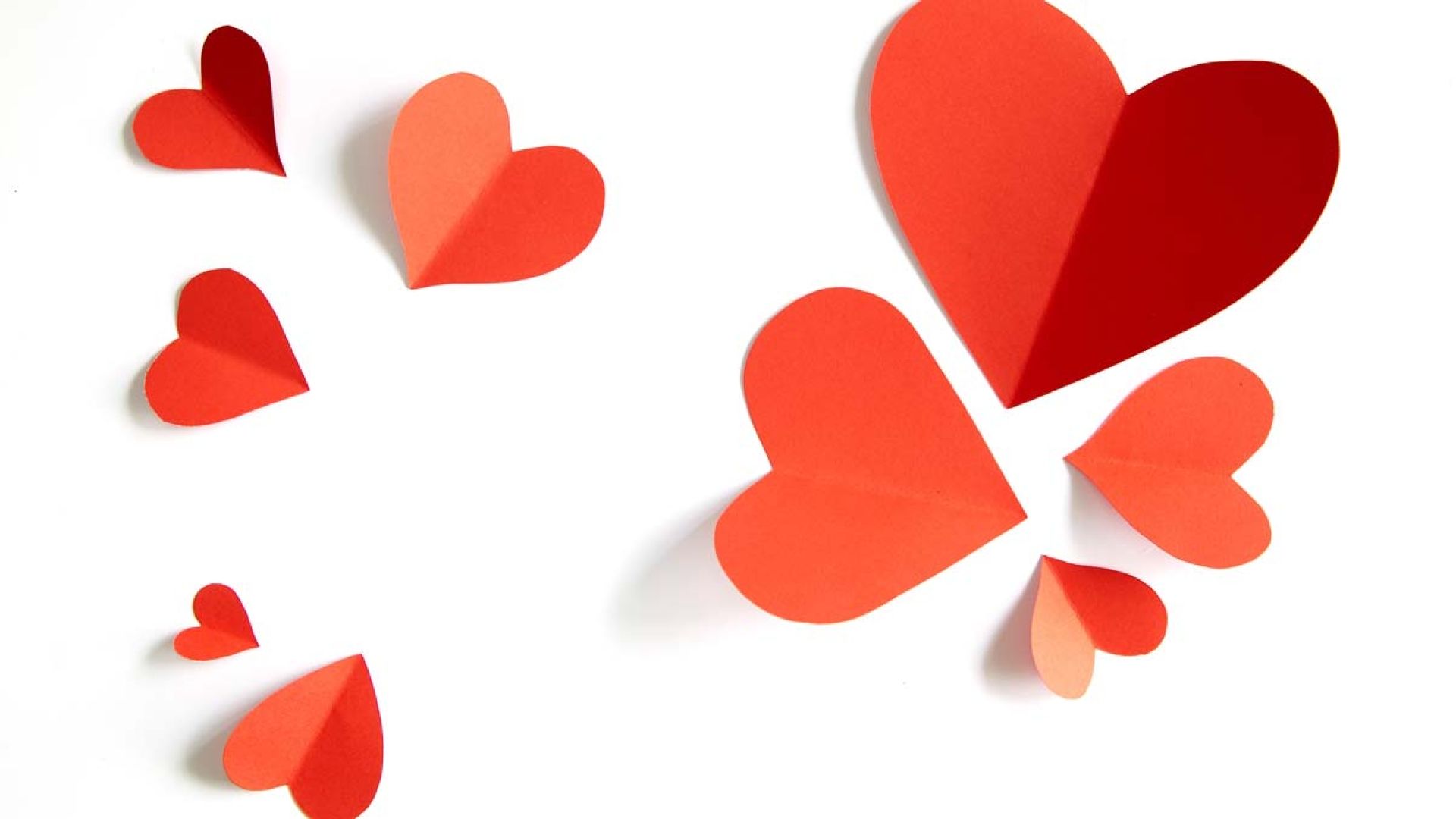 Red paper hearts on a white background