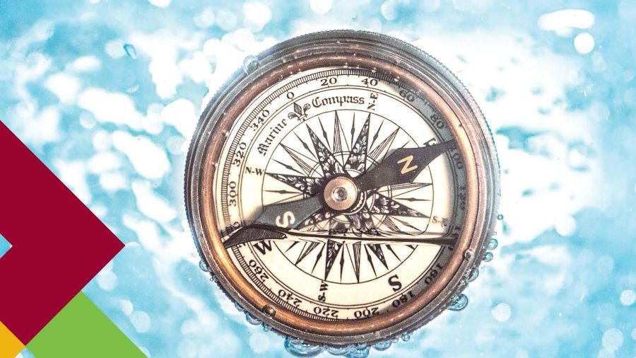 A compass against a blue background with graphic triangles on the side