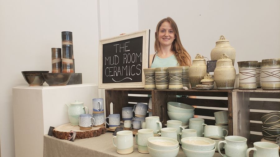 Student with her ceramics display