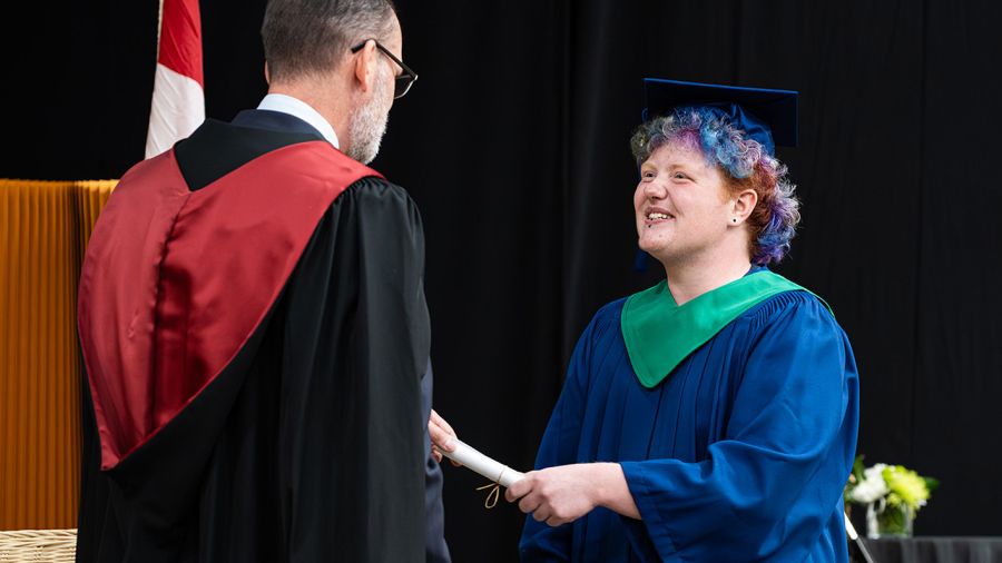 Student receiving scroll at Convocation