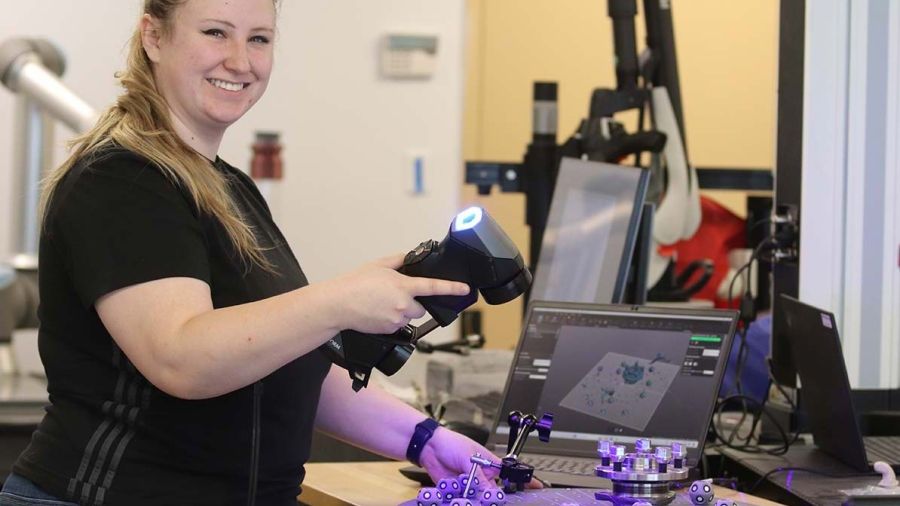 A student works with machines in advanced manufacturing