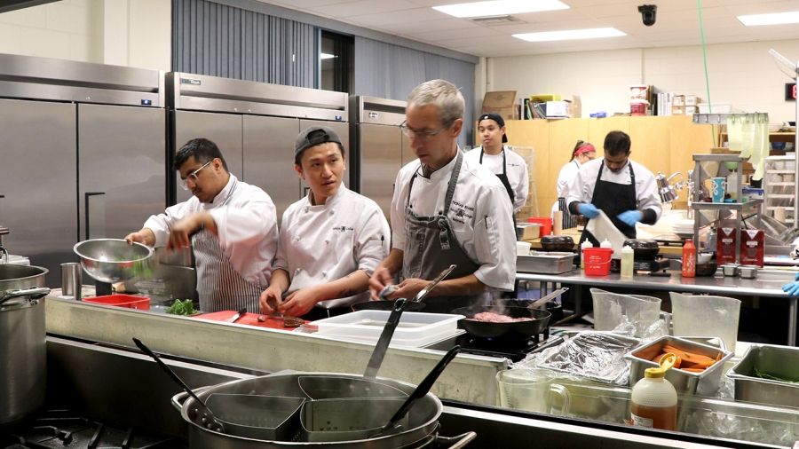 Students prepping in the Scholars Dining Room kitchen