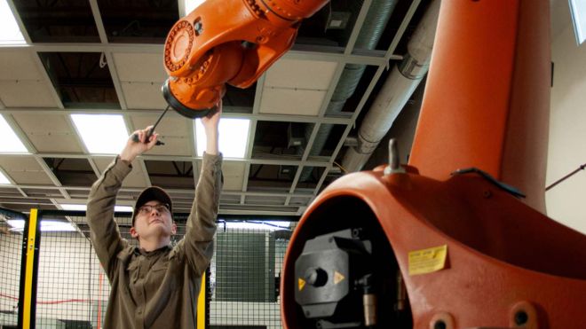 A student works with a large machine