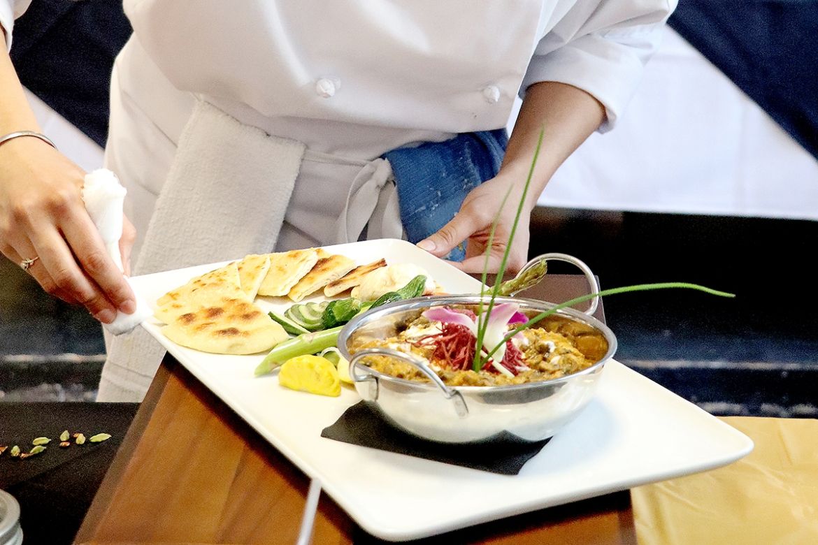 Cooking student plating food