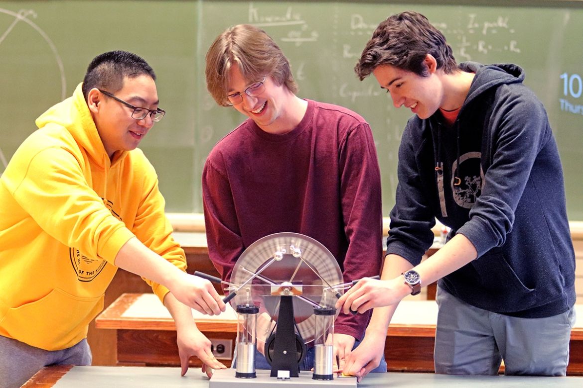 Engineering students learning on some equipment