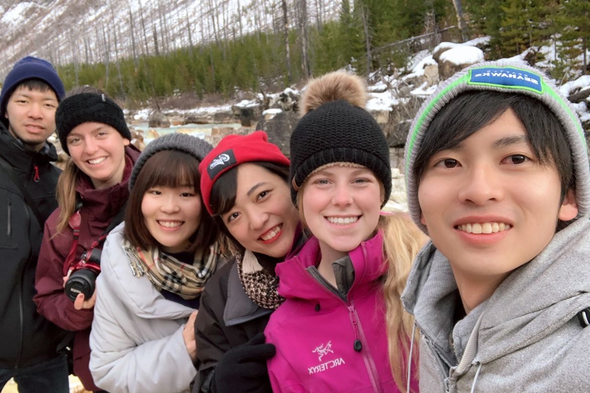 Students outside smiling