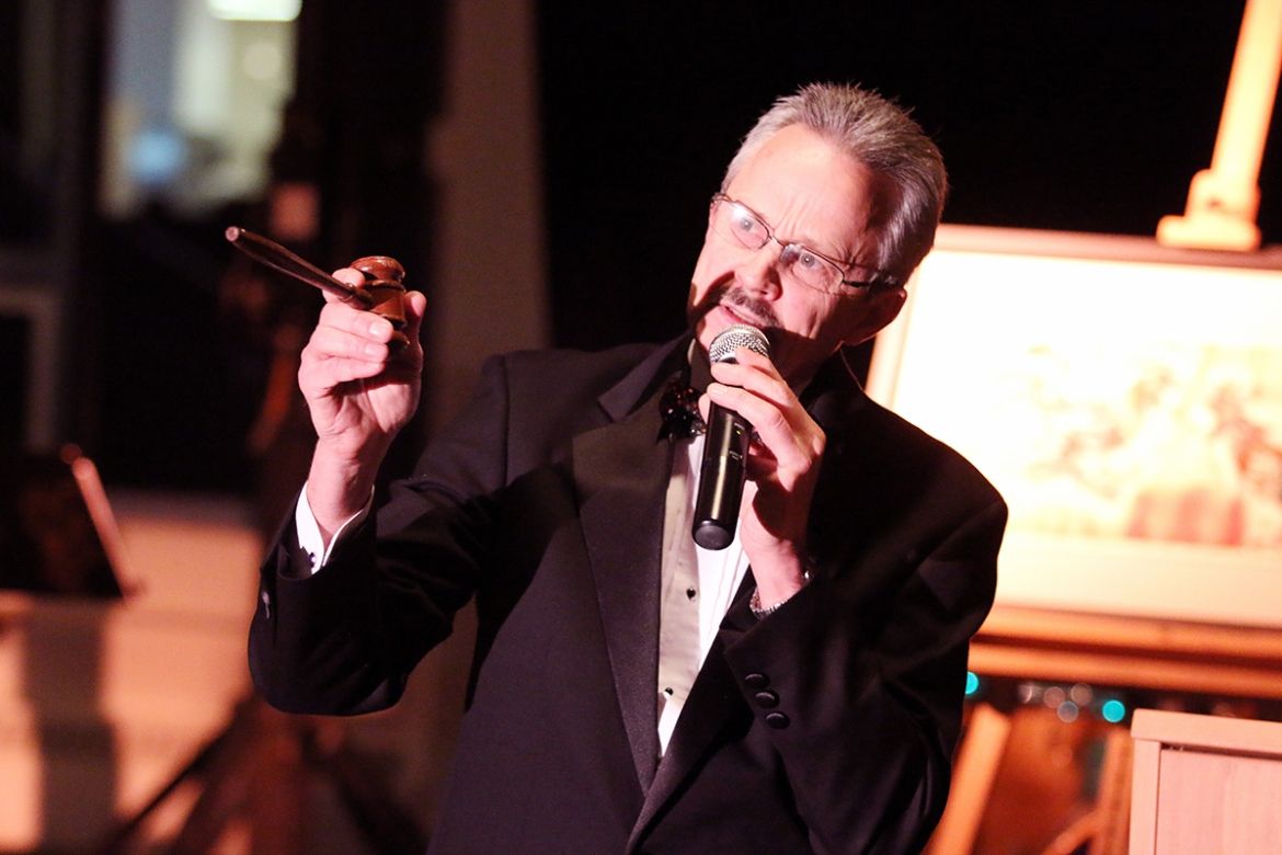 An auctioneer holds a gavel