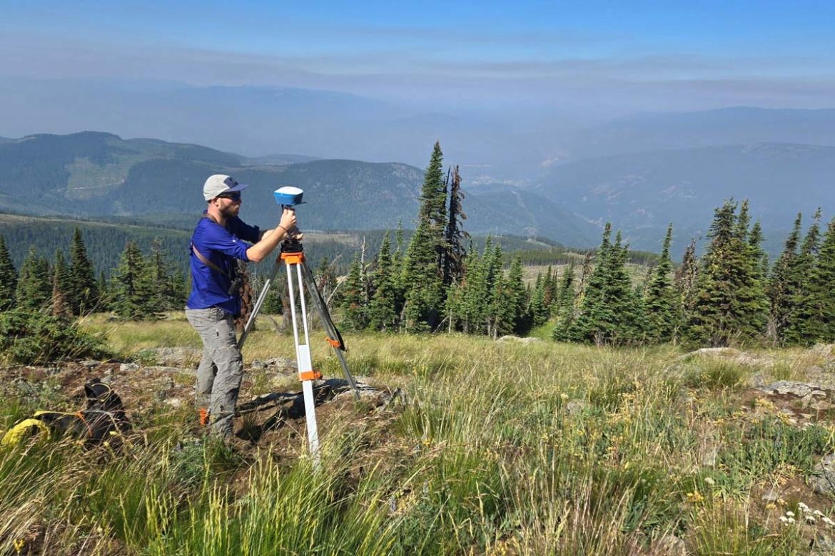 A GIS student works in a field