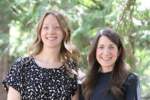 Recruiters Aimie and Beth stand outside and smile