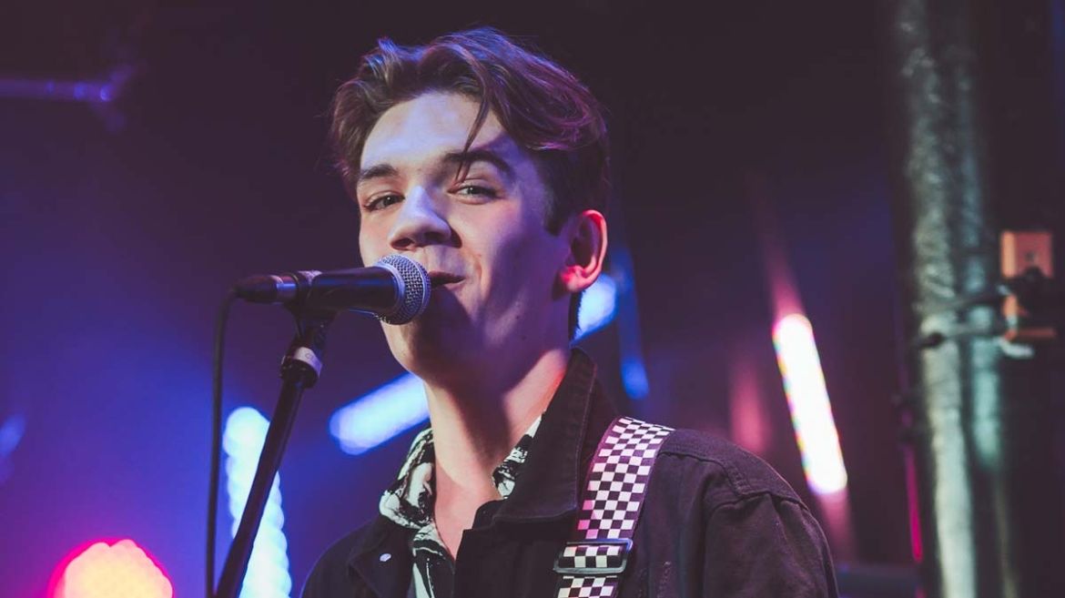 Drew sings into the microphone