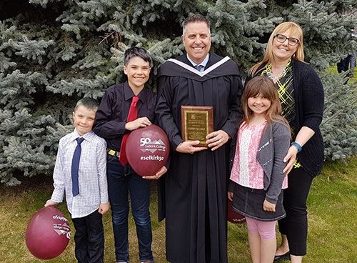 Currently the President and CEO of Panorama Resort in the East Kootenay, Steve Paccagnan's contribution to the industry was recognized in 2017 when he was honoured with the Selkirk College Distinguished Alumni Award at the annual Convocation at the Castlegar Campus. Steve posed for a photo with his family after the cermony.